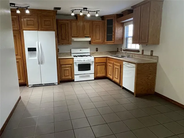 an empty room with windows and entrance