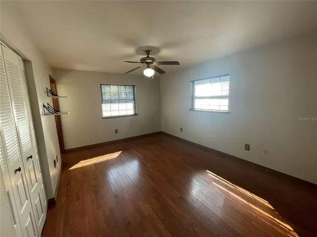 a bathroom with a granite countertop sink a toilet and mirror