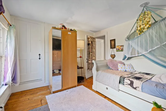 a bedroom with a bed and a mirror