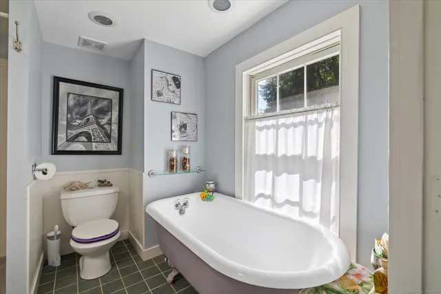 a bathroom with a toilet a sink and a bathtub