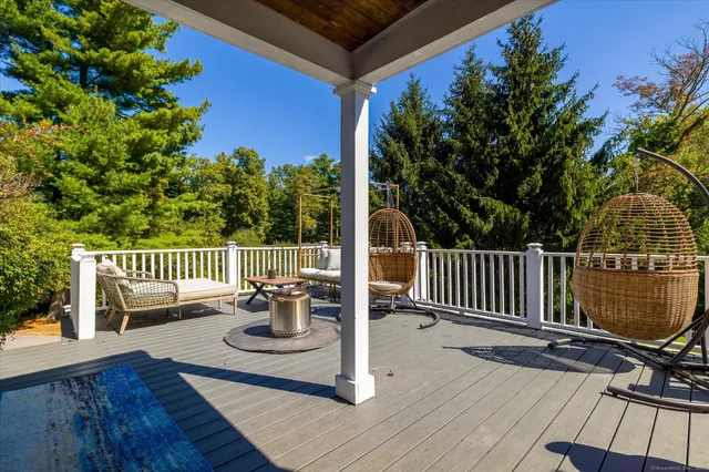 a view of a chairs and table on the wooden deck