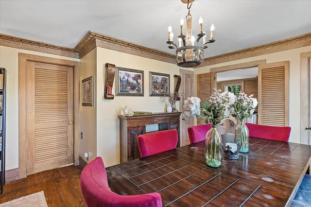a living room with furniture chandelier and a window