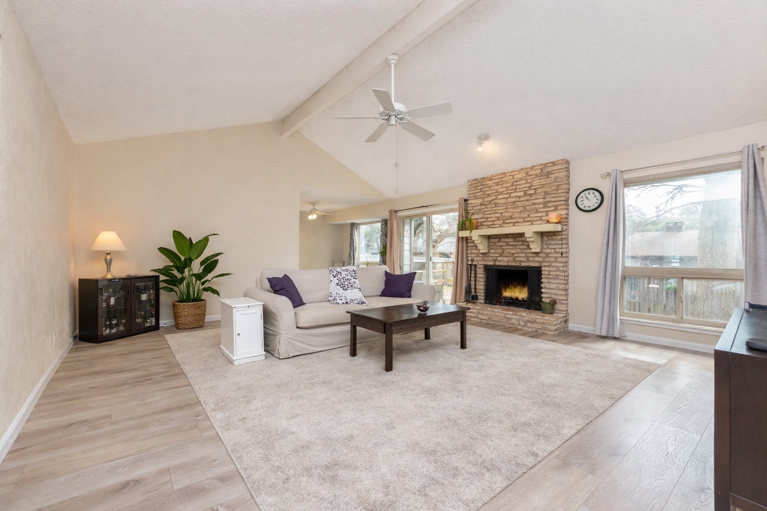 11719 Running Fox Trail Austin, TX 78759 - Photo 6 of 23 a living room with furniture a fireplace and a table