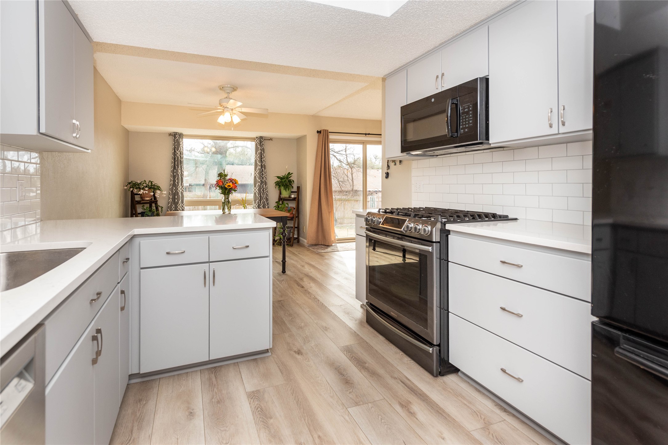 11719 Running Fox Trail Austin, TX 78759 - Photo 8 of 23 a kitchen with white cabinets appliances and sink