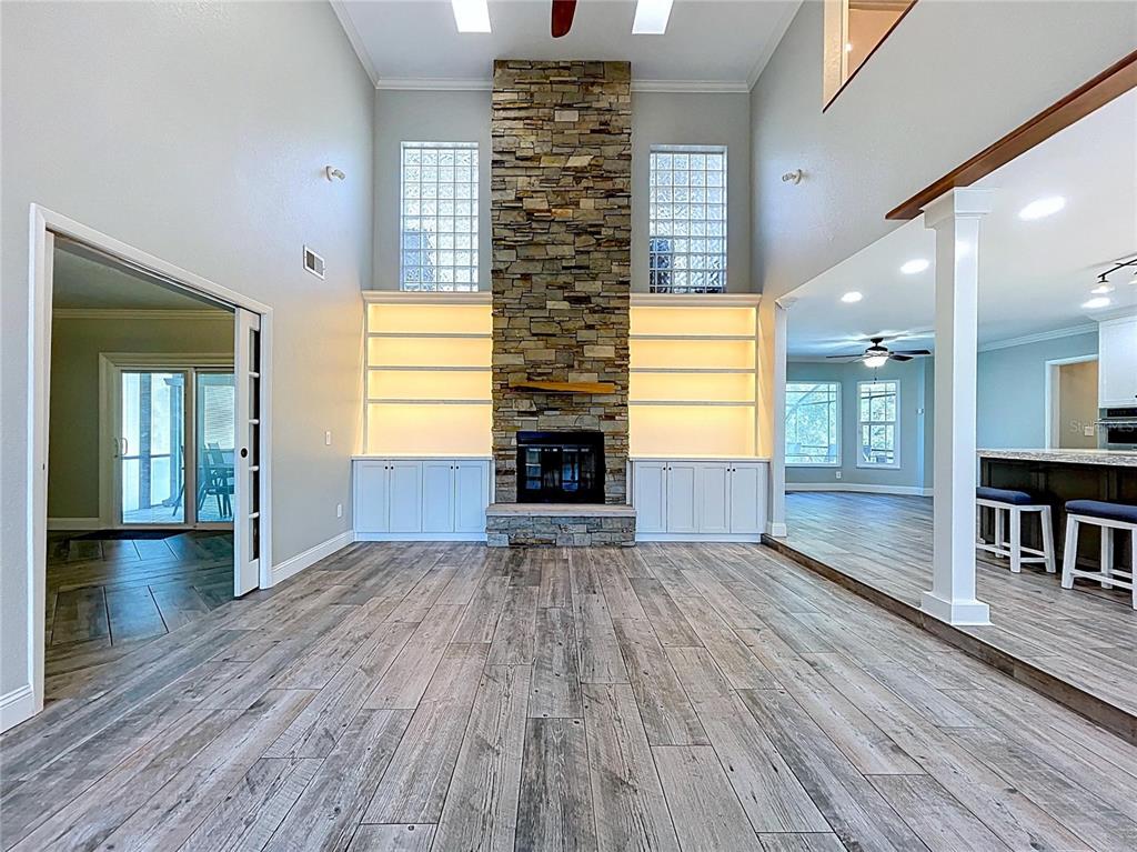 10655 Lakeview Drive New Port Richey, FL 34654 - Photo 11 of 83 a view of empty room with wooden floor and fireplace