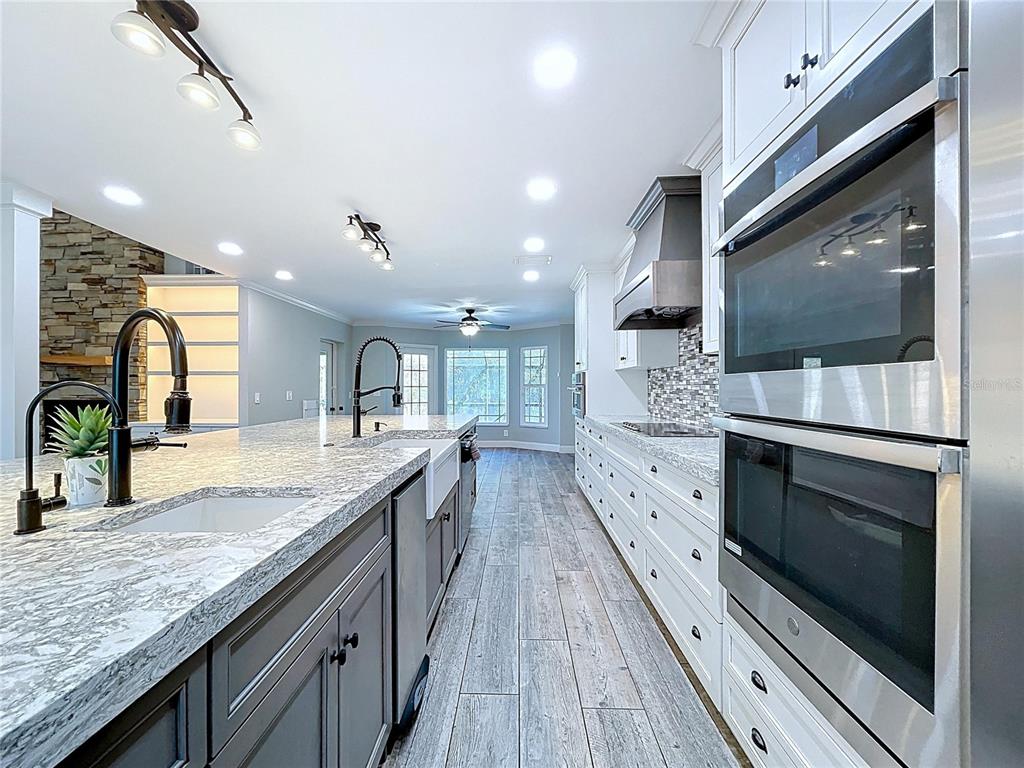 10655 Lakeview Drive New Port Richey, FL 34654 - Photo 18 of 83 a large kitchen with granite countertop a stove and a sink