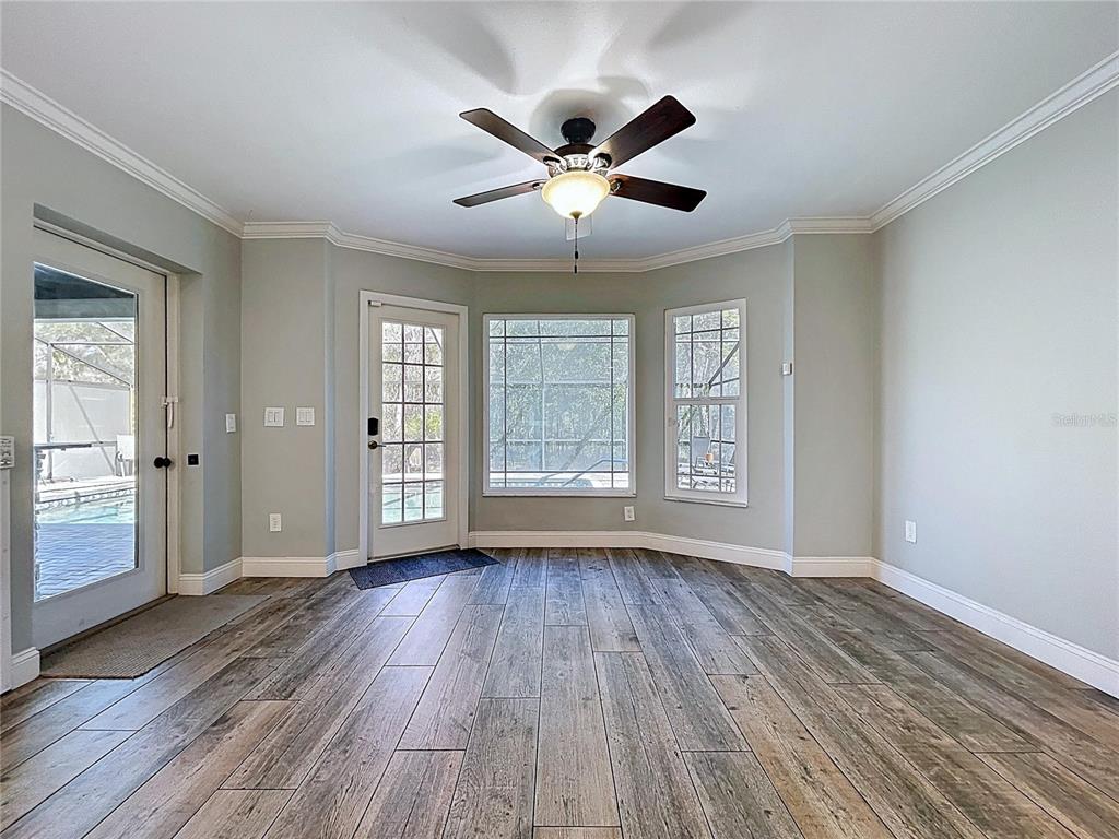 10655 Lakeview Drive New Port Richey, FL 34654 - Photo 23 of 83 a view of an empty room with wooden floor and a window