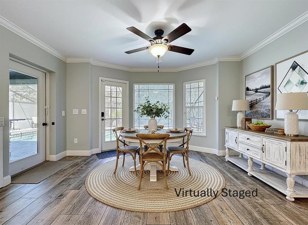 10655 Lakeview Drive New Port Richey, FL 34654 - Photo 24 of 83 a view of a dining room with furniture window and wooden floor