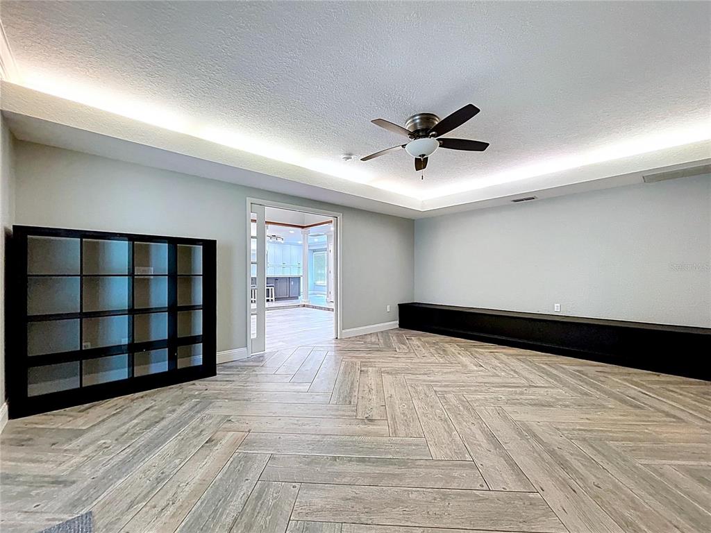 10655 Lakeview Drive New Port Richey, FL 34654 - Photo 25 of 83 a view of an empty room with a window and wooden floor