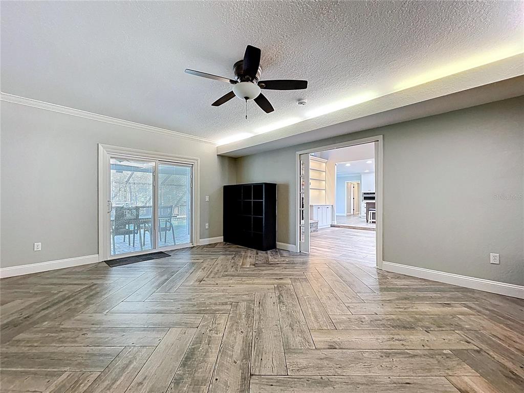 10655 Lakeview Drive New Port Richey, FL 34654 - Photo 27 of 83 a view of an empty room with wooden floor and a window
