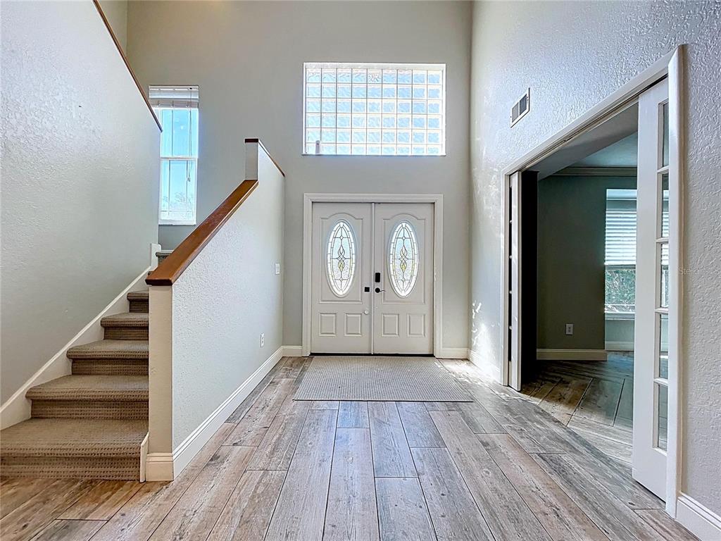 10655 Lakeview Drive New Port Richey, FL 34654 - Photo 32 of 83 a view of an entryway with wooden floor and stairs