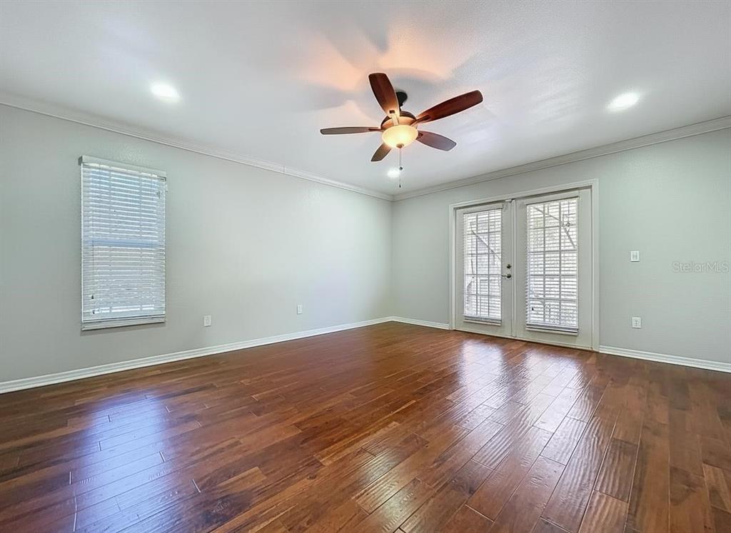 10655 Lakeview Drive New Port Richey, FL 34654 - Photo 36 of 83 a view of an empty room with wooden floor and a window