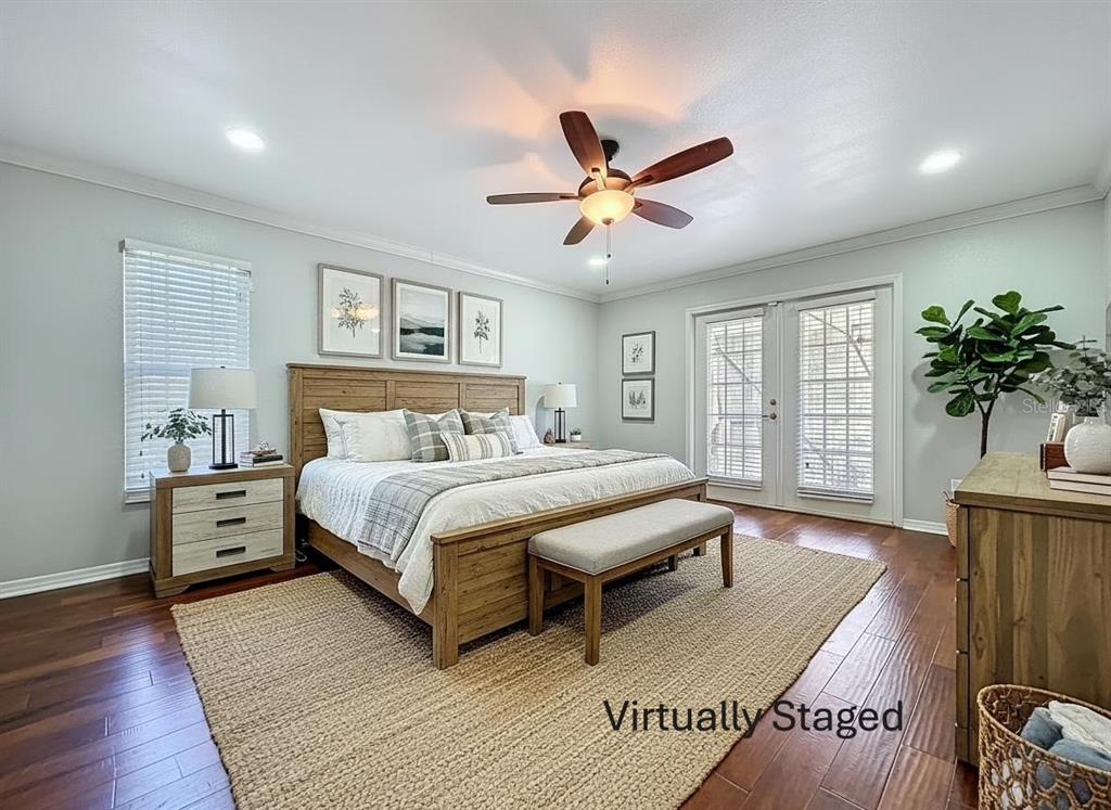 10655 Lakeview Drive New Port Richey, FL 34654 - Photo 37 of 83 a bedroom with a large bed and a chandelier