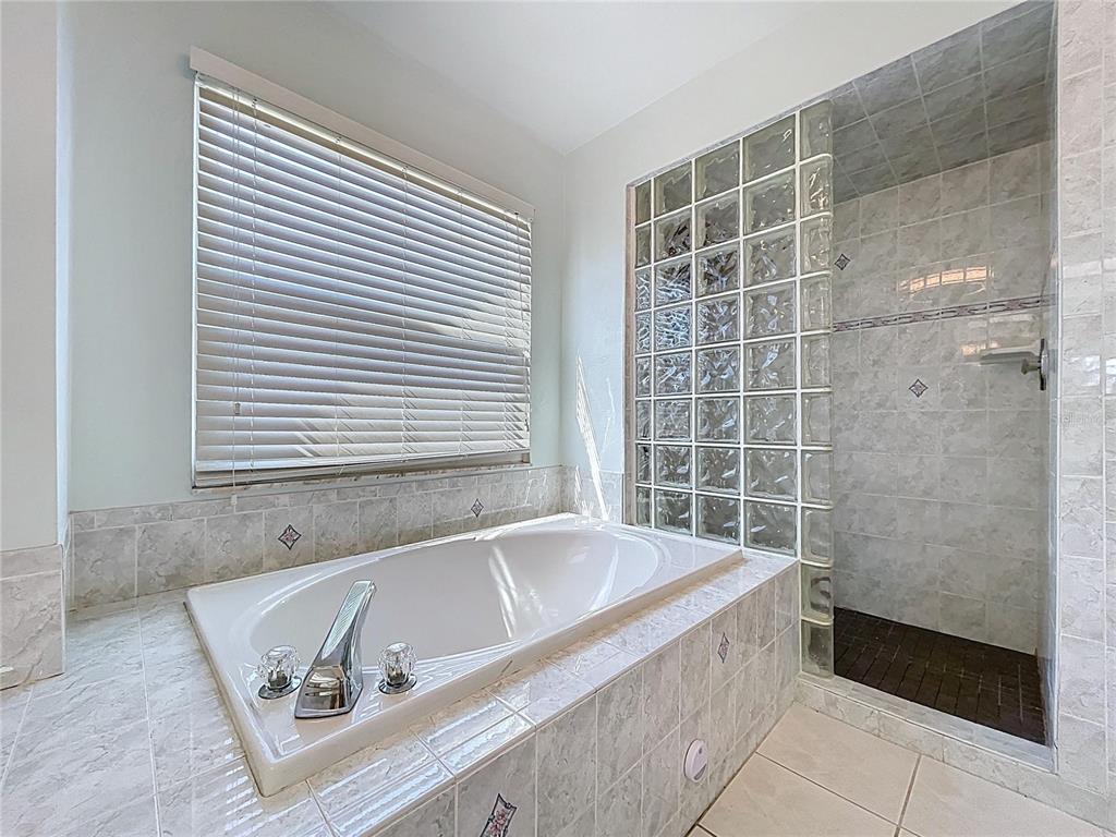 10655 Lakeview Drive New Port Richey, FL 34654 - Photo 40 of 83 a bath tub sitting in a bathroom next to a window
