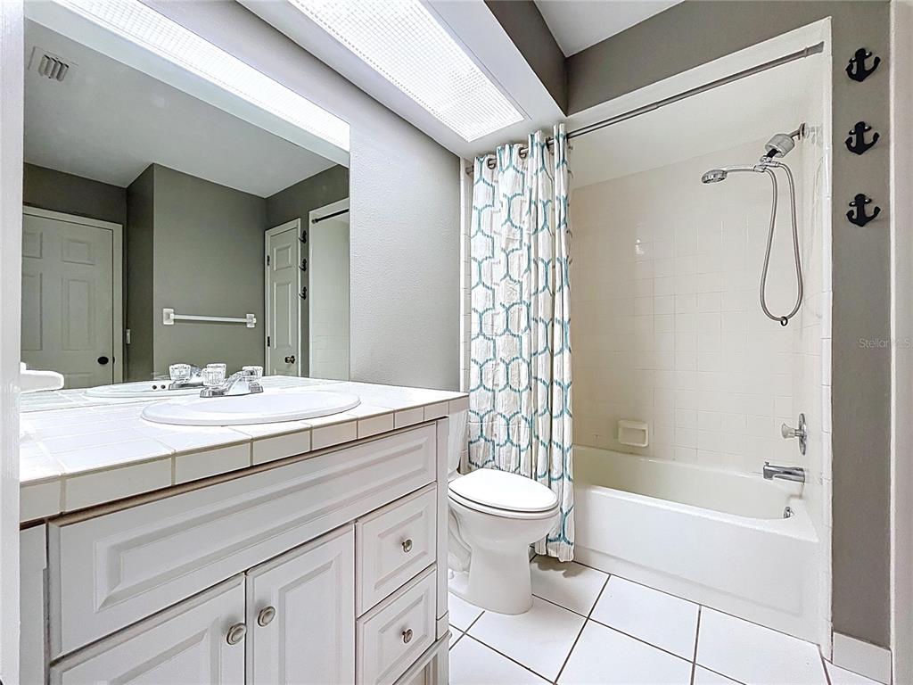 10655 Lakeview Drive New Port Richey, FL 34654 - Photo 45 of 83 a bathroom with a granite countertop sink a toilet and shower