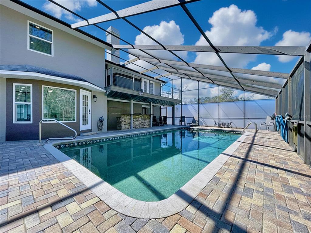 10655 Lakeview Drive New Port Richey, FL 34654 - Photo 62 of 83 a view of a swimming pool with a patio