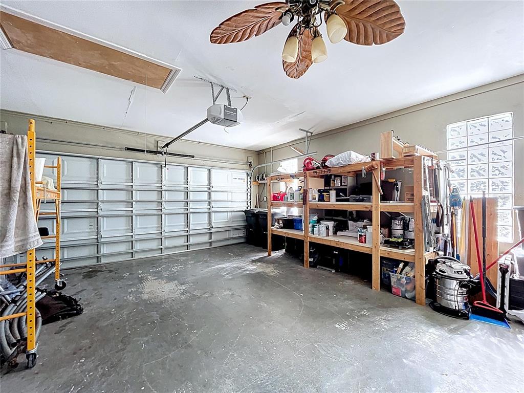 10655 Lakeview Drive New Port Richey, FL 34654 - Photo 74 of 83 a view of a garage with furniture and a fan