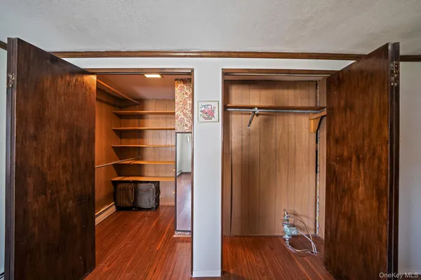 a bedroom with bed window and wooden floor