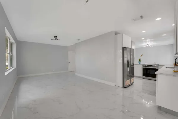 a view of a kitchen with a sink and a refrigerator