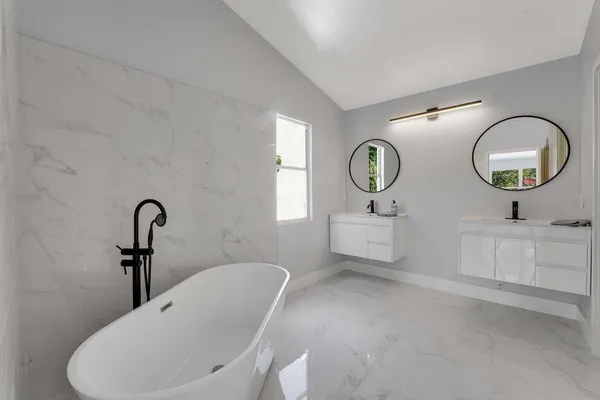 a bathroom with a toilet a sink and a mirror