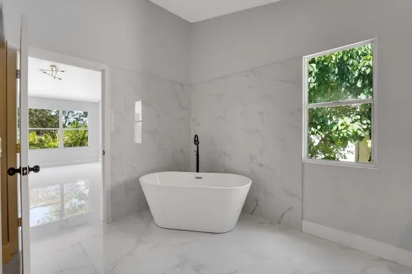 a bathroom with a bathtub and window