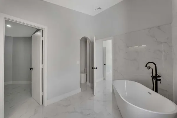 a bathroom with a tub and sink