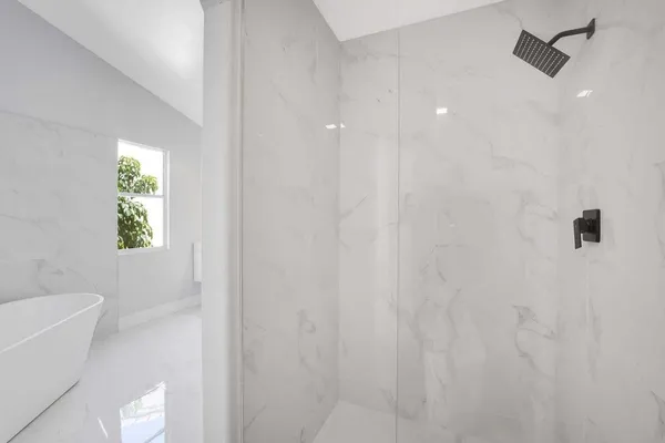 a bathroom with a bathtub and shower