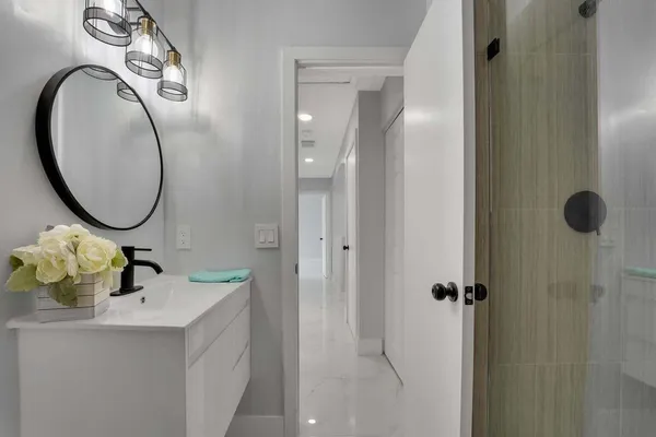 a bathroom with a sink vanity and mirror