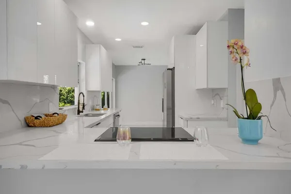 a kitchen with a sink and a chandelier