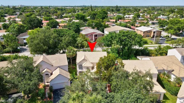 an aerial view of residential houses with outdoor space and street view