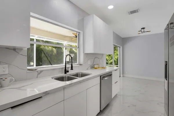 a kitchen with kitchen island a sink and a window