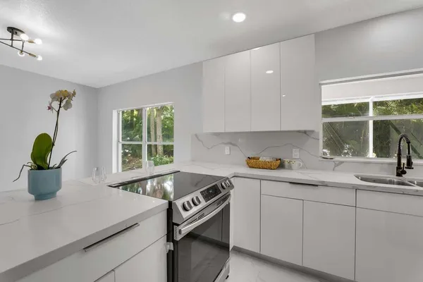 a kitchen with a sink and white cabinets