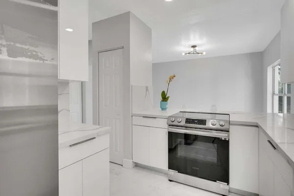 a kitchen with a stove and a refrigerator