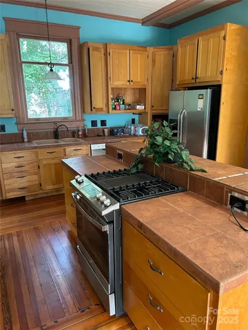 a kitchen with a stove a sink and a refrigerator