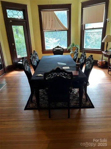 a living room with furniture wooden floor and a large window