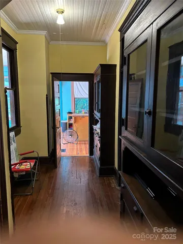 a hallway with a large mirror and a dresser
