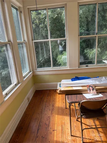 a view of a room with window and furniture