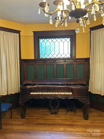 a living room with a bed furniture and a window