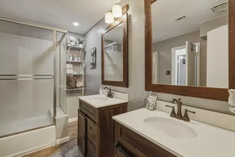 a bathroom with a double vanity sink mirror and double