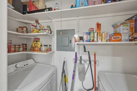 a utility room with fridge dryer and washer