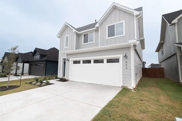 a view of a house with backyard