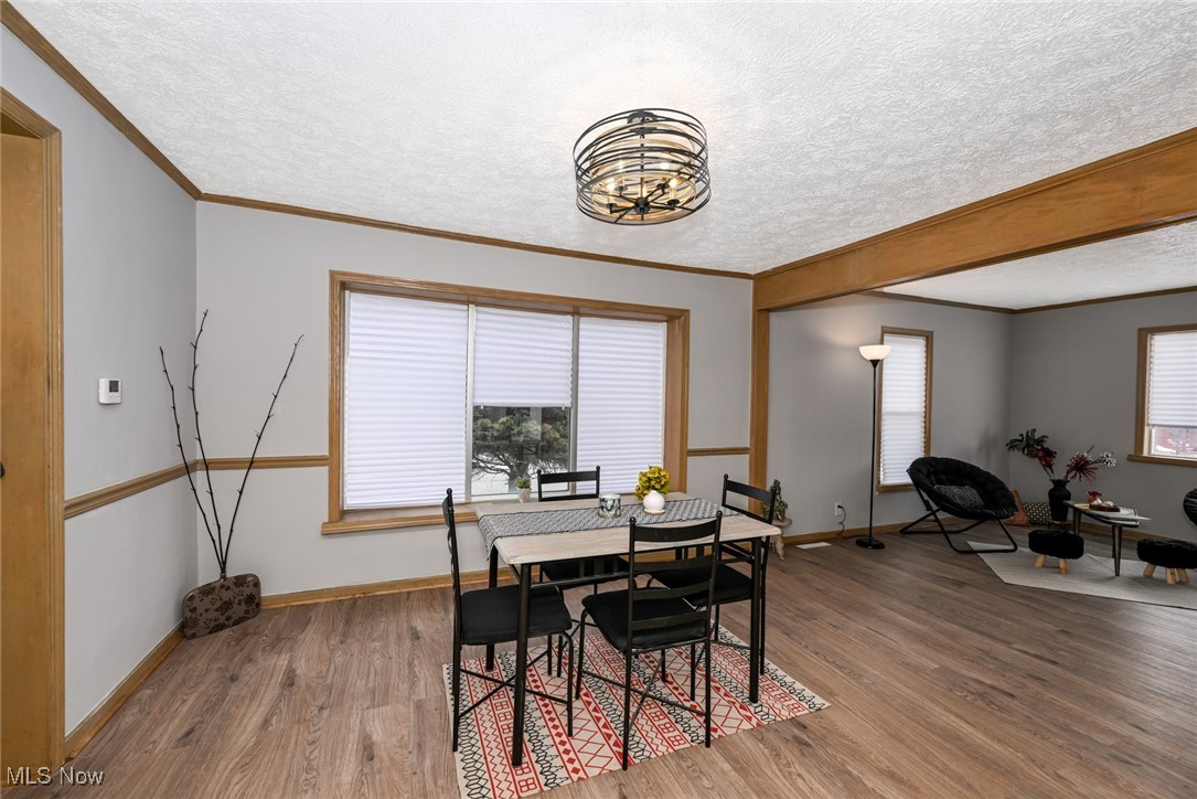 1164 Copley Road Akron, OH 44320 - Photo 15 of 50 Dining space with a textured ceiling, baseboards, wood finished floors, and ornamental molding