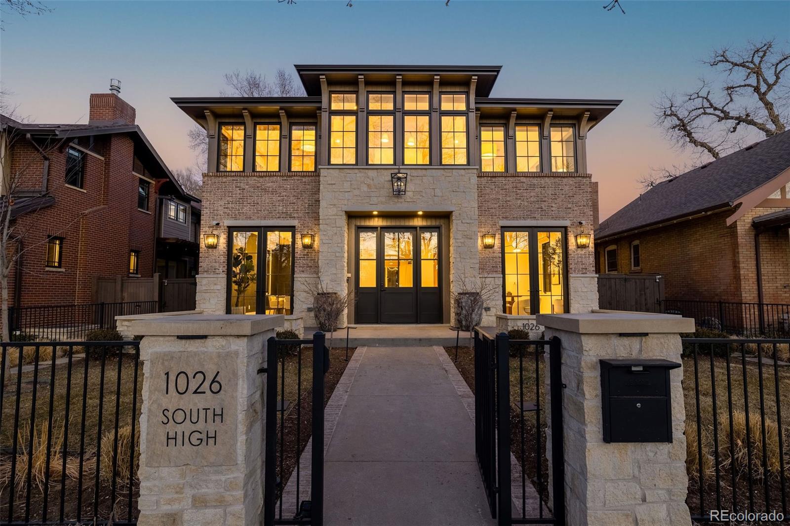 a front view of a brick house with many windows