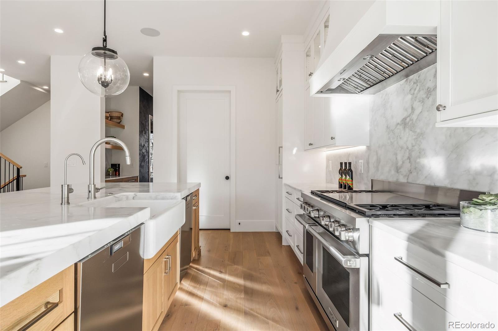 1026 South High Street Denver, CO 80209 - Photo 12 of 50 a kitchen with stainless steel appliances granite countertop a stove and a sink