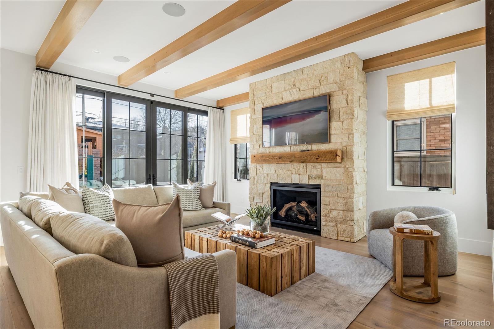 1026 South High Street Denver, CO 80209 - Photo 18 of 50 a living room with furniture and a fireplace