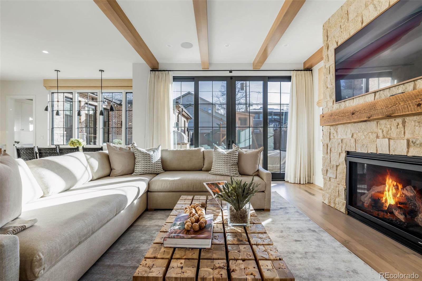 1026 South High Street Denver, CO 80209 - Photo 20 of 50 a living room with furniture a large window and a fireplace