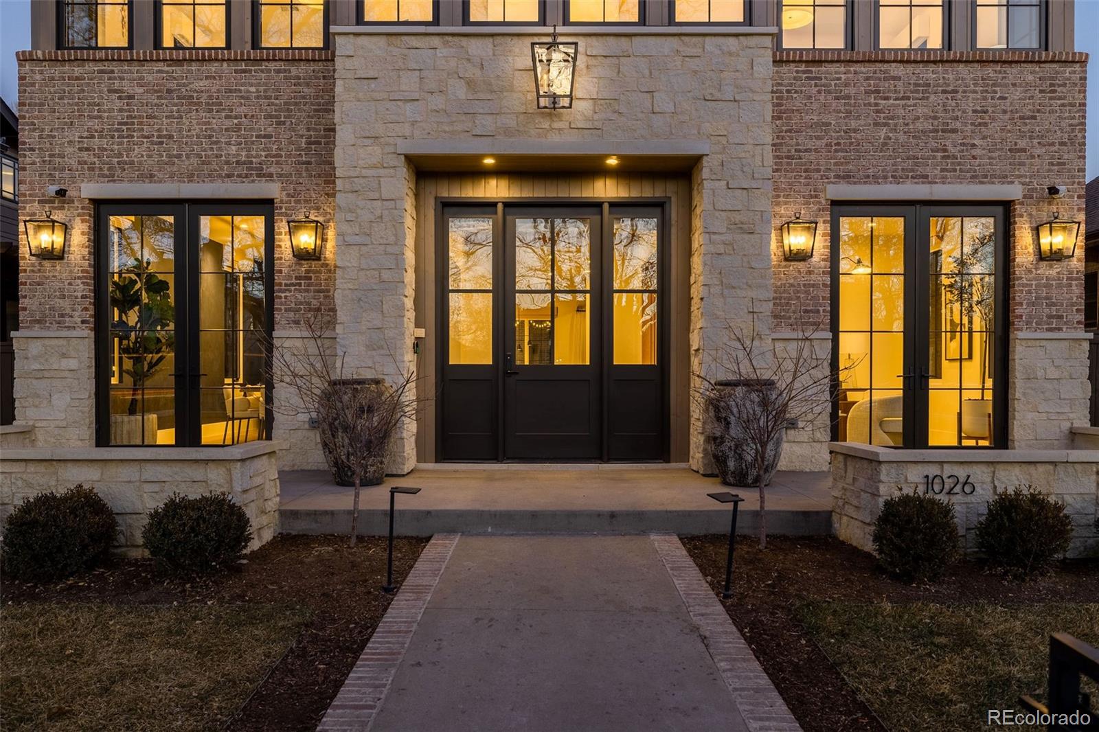 1026 South High Street Denver, CO 80209 - Photo 2 of 50 a front view of a house with a yard