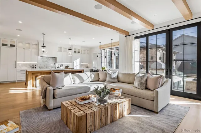 a bathroom with a granite countertop double vanity sink a mirror and a toilet