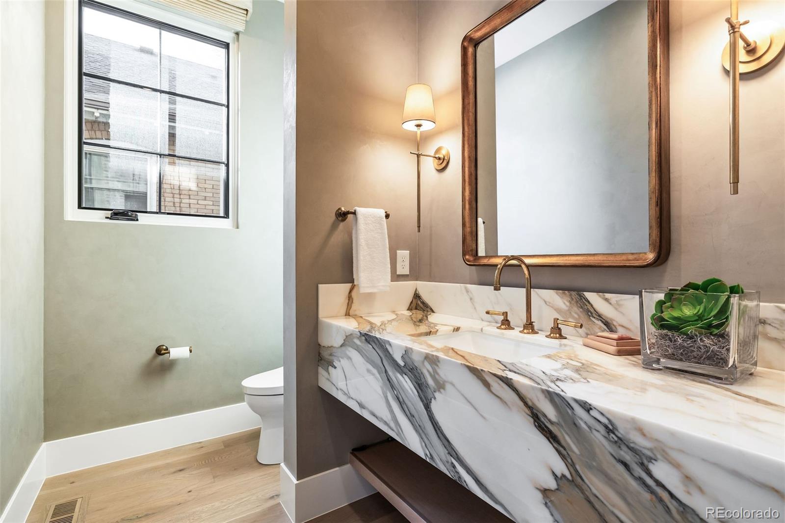 1026 South High Street Denver, CO 80209 - Photo 22 of 50 a bathroom with a granite countertop double vanity sink a mirror and a toilet