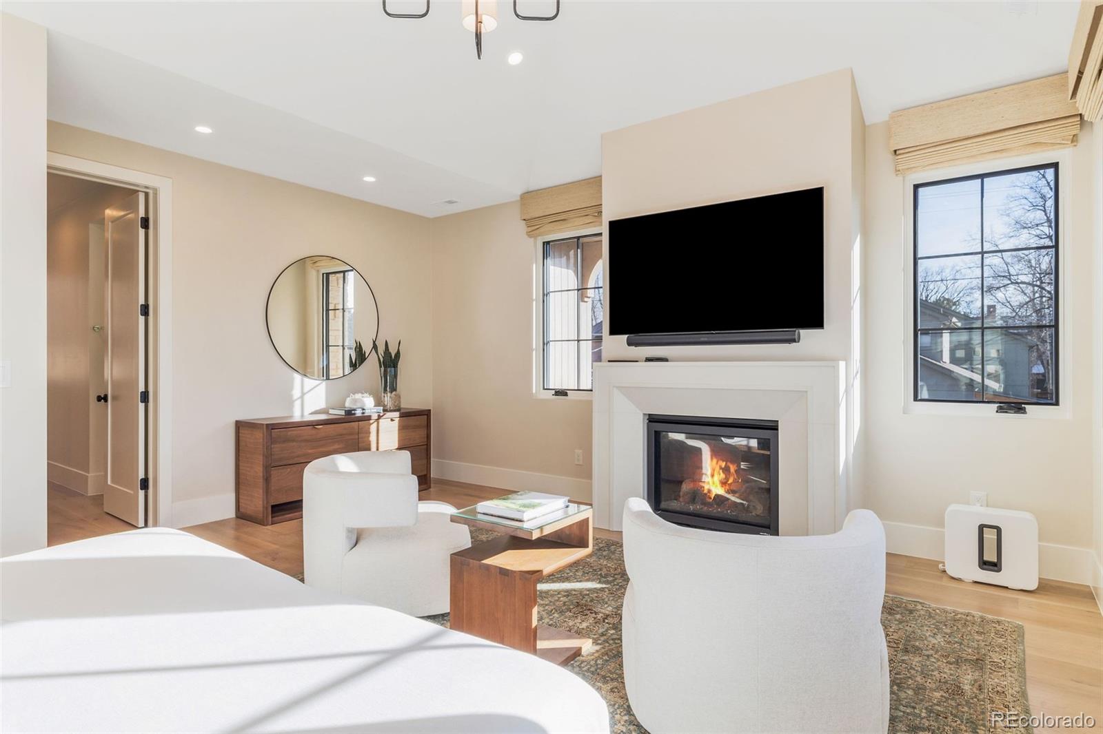 1026 South High Street Denver, CO 80209 - Photo 26 of 50 a living room with furniture a fireplace and a flat screen tv